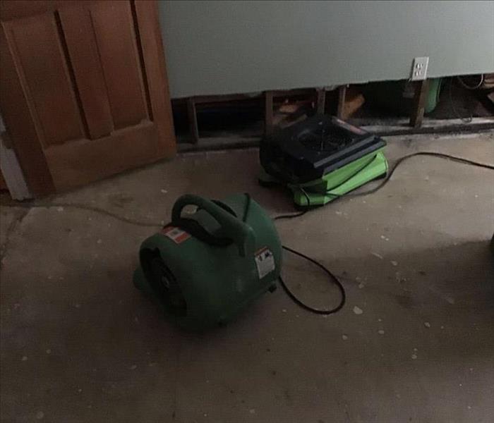 Drying equipment on floor after water damage.