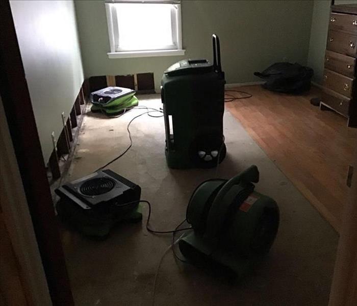 Drying equipment set up in an empty room.