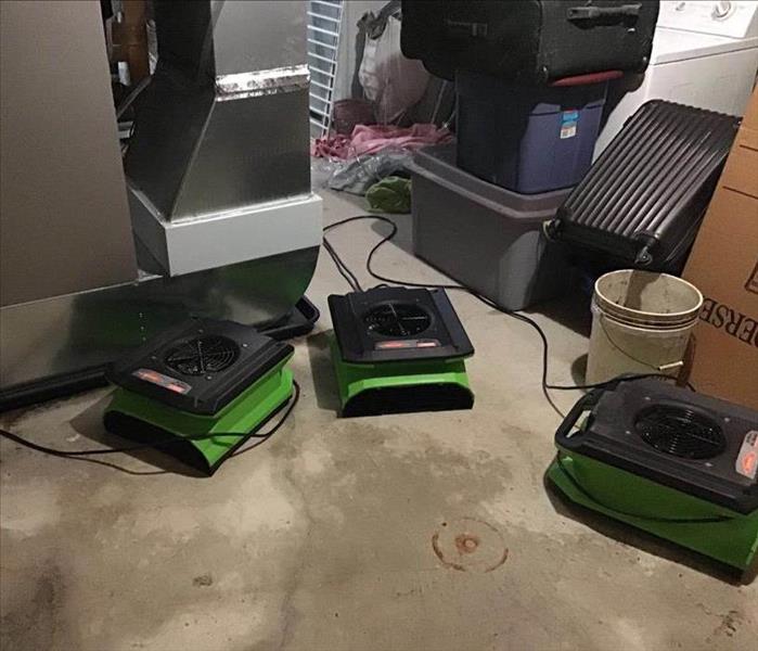 Air movers on basement floor.