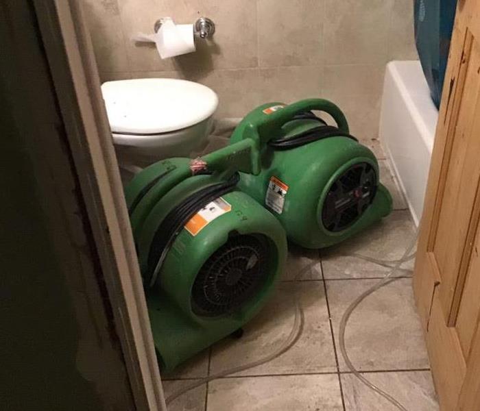 Drying equipment on bathroom floor.