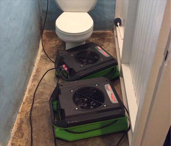 Drying equipment on bathroom floor.